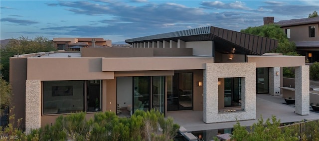 rear view of property featuring a patio area