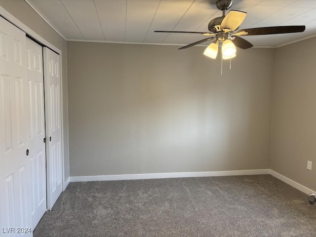 unfurnished bedroom with crown molding, ceiling fan, carpet floors, and a closet