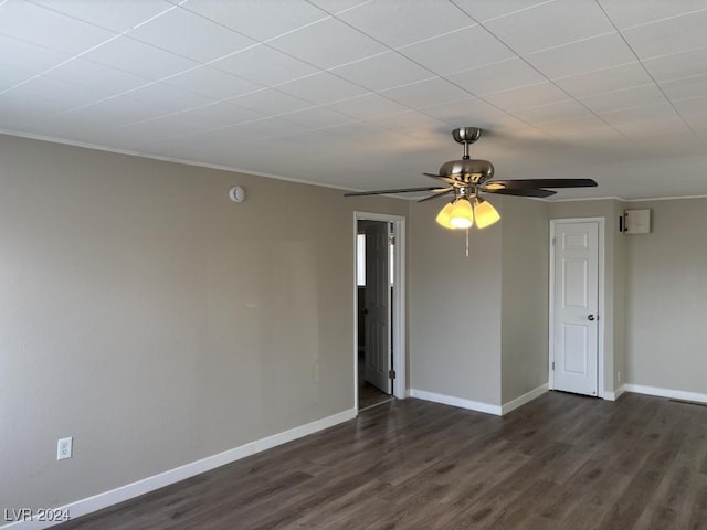 empty room featuring ceiling fan and dark hardwood / wood-style flooring