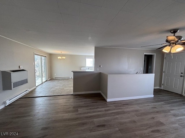 unfurnished living room with hardwood / wood-style flooring and baseboard heating