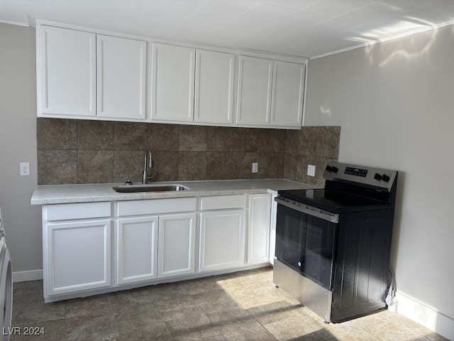 kitchen with white cabinetry, sink, decorative backsplash, and electric stove