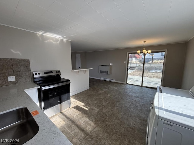 kitchen with stainless steel electric stove, pendant lighting, washer / clothes dryer, baseboard heating, and an inviting chandelier