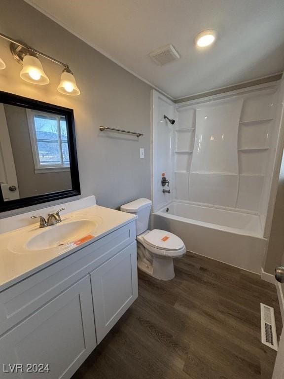 full bathroom with toilet, vanity, bathtub / shower combination, and hardwood / wood-style floors