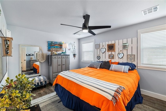 bedroom with dark hardwood / wood-style floors and ceiling fan