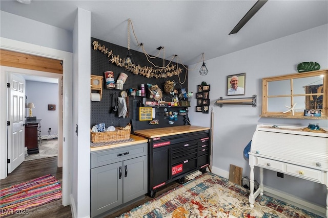 kitchen featuring gray cabinetry and dark hardwood / wood-style flooring