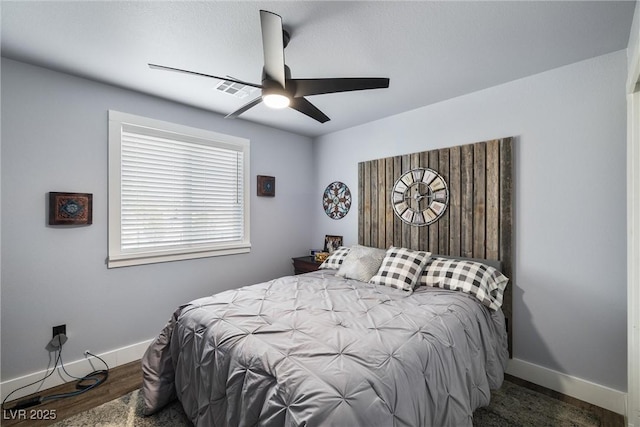 bedroom with dark wood-type flooring and ceiling fan