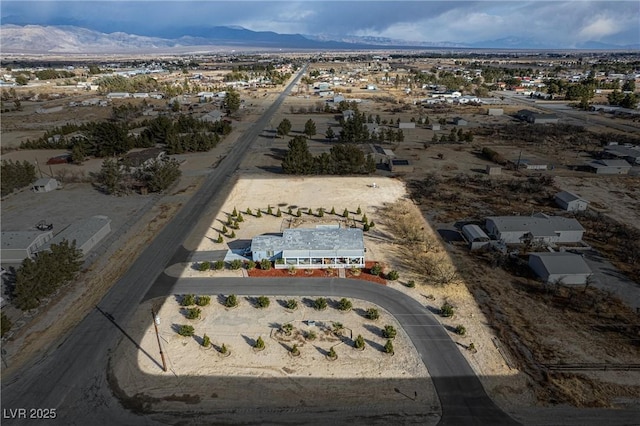 birds eye view of property featuring a mountain view