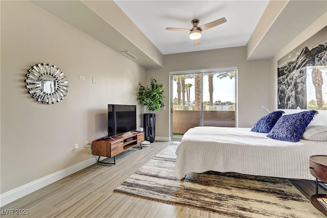 bedroom with ceiling fan, wood-type flooring, and access to exterior