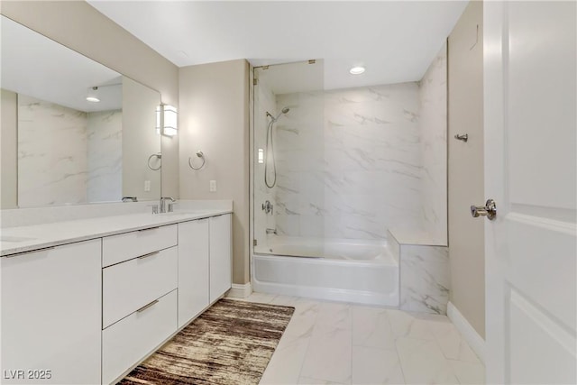 bathroom with vanity and tiled shower / bath combo