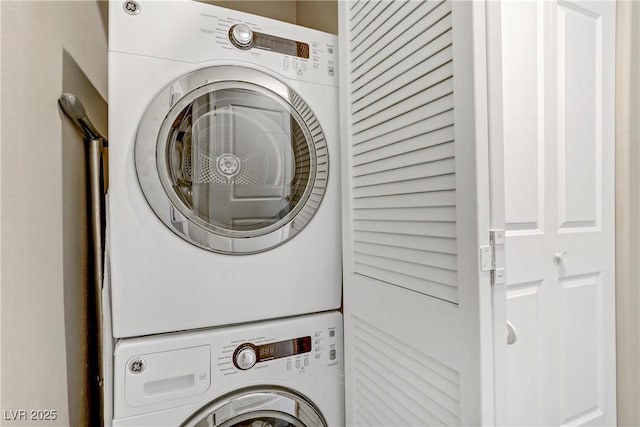 washroom featuring stacked washer / drying machine