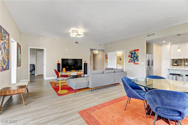 living room with sink and light wood-type flooring