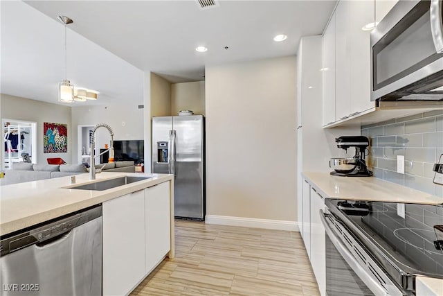 kitchen featuring white cabinetry, stainless steel appliances, and sink