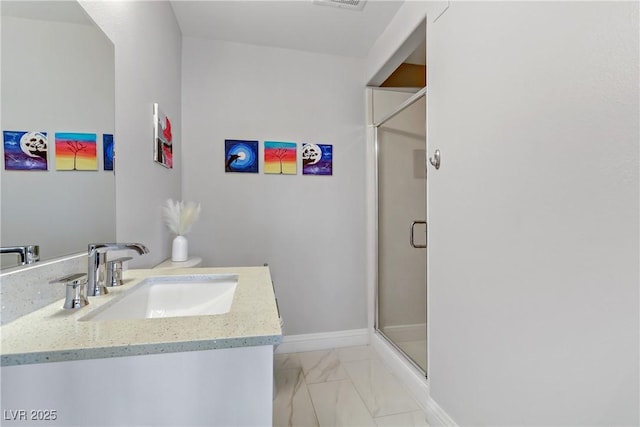 bathroom with vanity and a shower with shower door