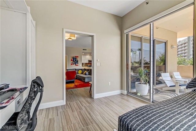 bedroom with access to outside and light hardwood / wood-style floors