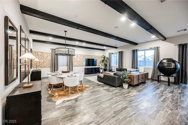 living room with beamed ceiling and wood-type flooring