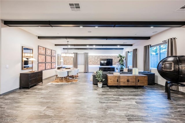 living room featuring hardwood / wood-style floors, a notable chandelier, and beam ceiling