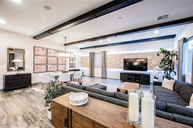 living room with beamed ceiling and light hardwood / wood-style floors