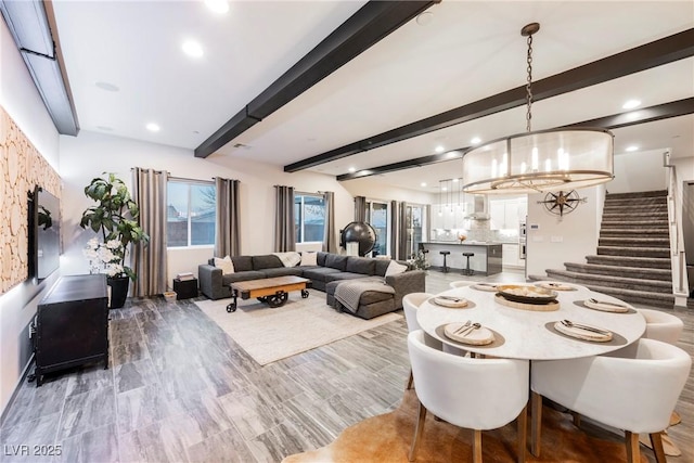 dining space featuring beamed ceiling