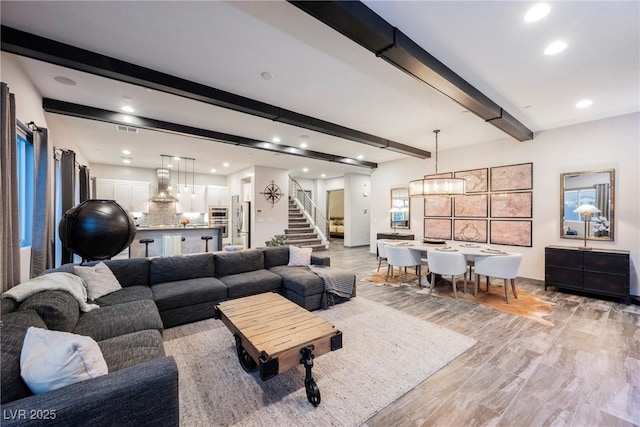 living room featuring beam ceiling and light wood-type flooring