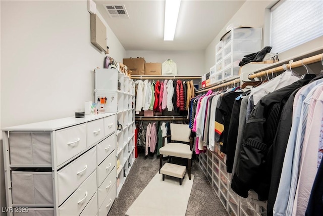 spacious closet with dark carpet