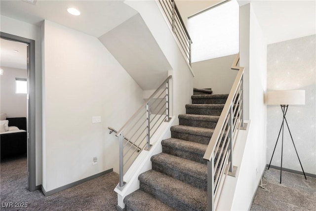 stairs featuring carpet flooring