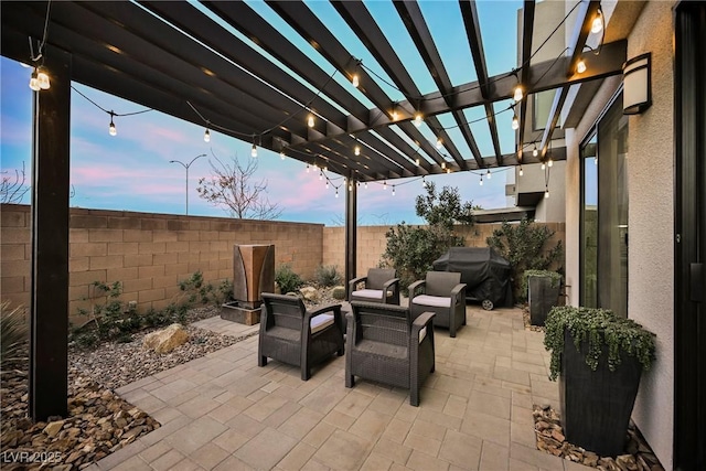 patio terrace at dusk featuring area for grilling, an outdoor living space, and a pergola