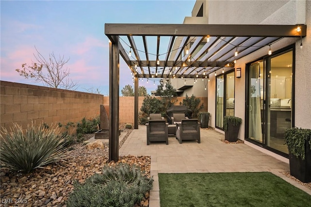 patio terrace at dusk with outdoor lounge area and a pergola