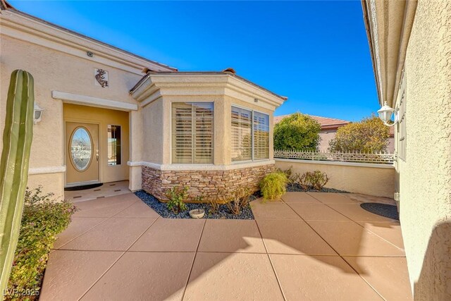 view of exterior entry featuring a patio