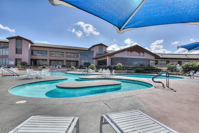 view of swimming pool with a patio