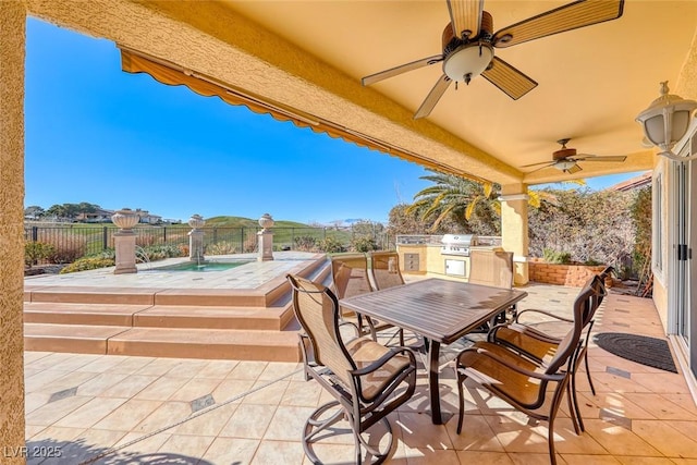 view of patio / terrace with pool water feature, ceiling fan, and exterior kitchen