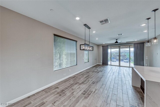 interior space with ceiling fan and light hardwood / wood-style flooring