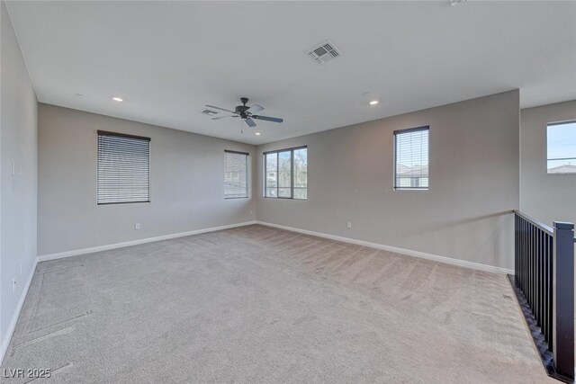 unfurnished room featuring light carpet and ceiling fan