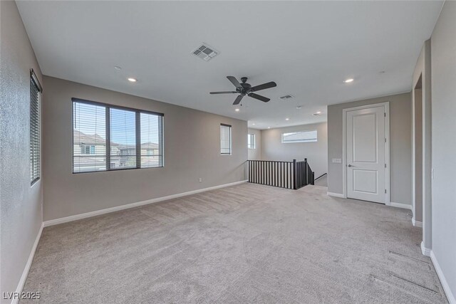 unfurnished living room featuring light colored carpet and ceiling fan