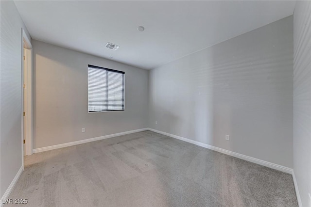 unfurnished room featuring light colored carpet