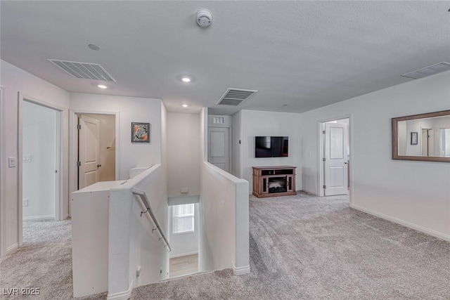 hall featuring light colored carpet