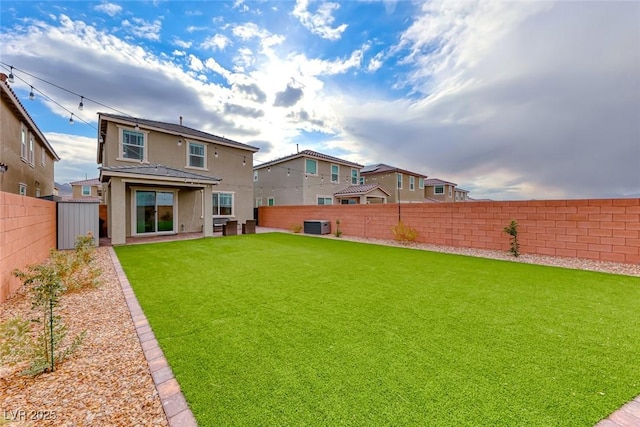 rear view of house featuring a yard and central air condition unit