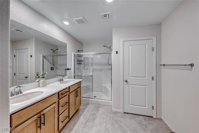 bathroom featuring tile patterned flooring, vanity, and a shower with door