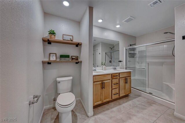 bathroom with an enclosed shower, vanity, tile patterned floors, and toilet