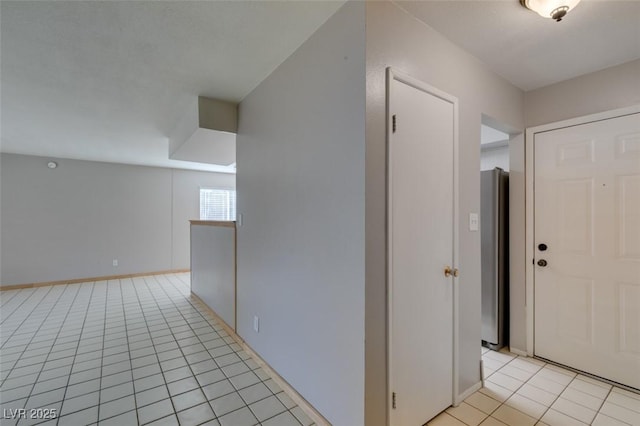 hall featuring light tile patterned flooring