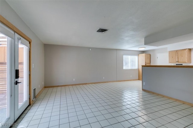 spare room featuring light tile patterned floors