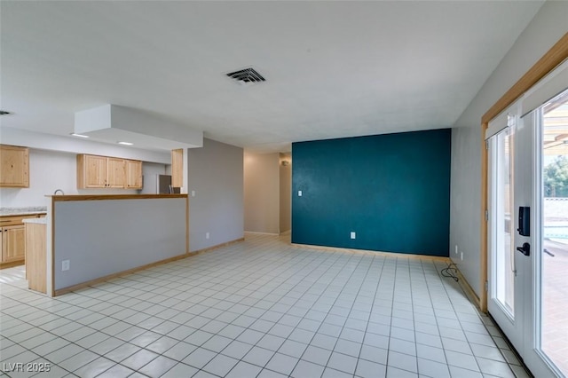 unfurnished living room featuring light tile patterned floors