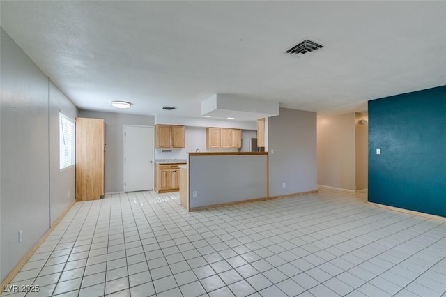 unfurnished living room featuring light tile patterned floors