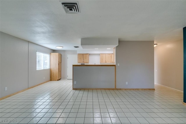 unfurnished living room with light tile patterned floors