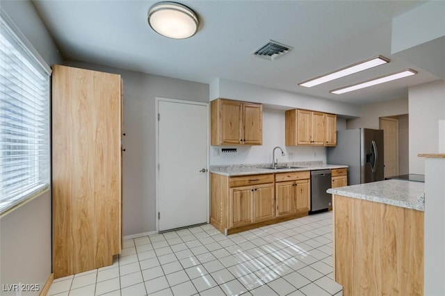 kitchen with sink, stainless steel appliances, and light tile patterned flooring