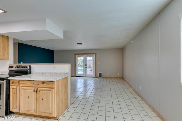 kitchen with french doors, stainless steel electric stove, light tile patterned flooring, and light brown cabinetry