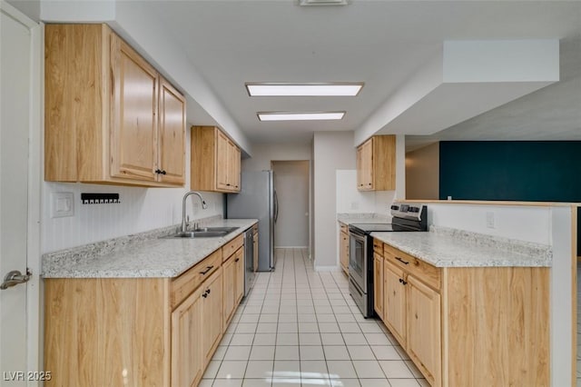 kitchen featuring sink, light stone counters, light brown cabinets, light tile patterned floors, and stainless steel appliances