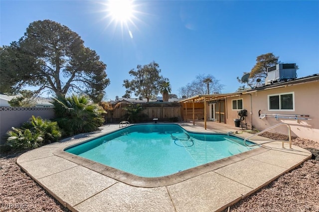 view of swimming pool with a patio area and central air condition unit