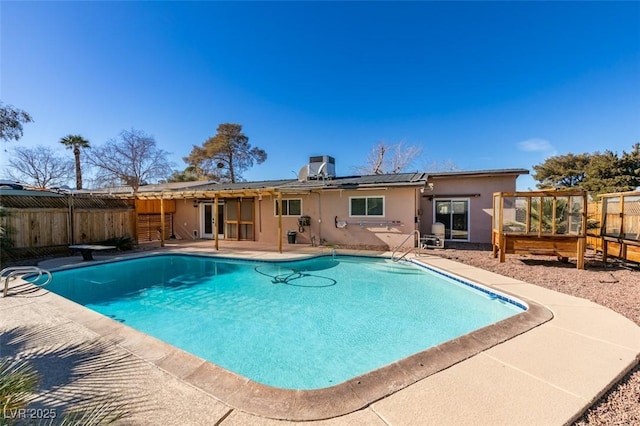 view of pool featuring central AC, a patio area, and a diving board