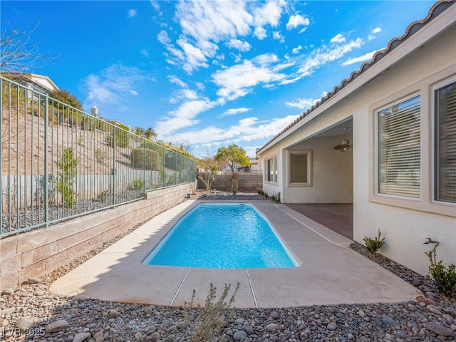 view of pool featuring ceiling fan and a patio area