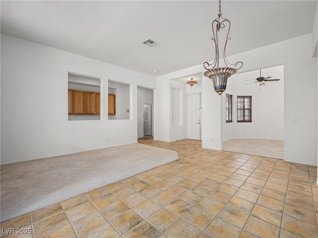 empty room featuring light carpet and ceiling fan